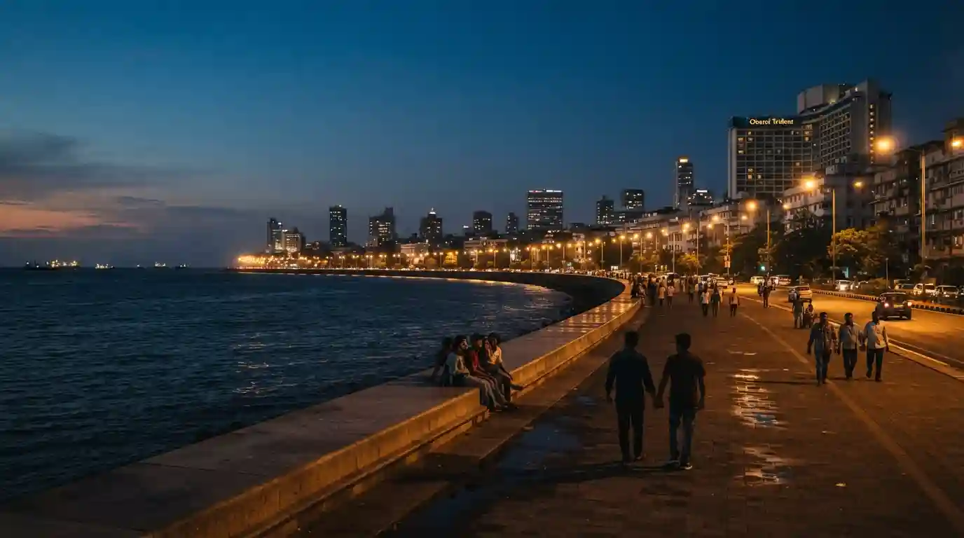Marine Drive glowing along Mumbai's coastline after sunset with city lights and skyline views